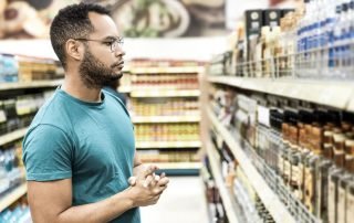 Liquor store black man looking at products